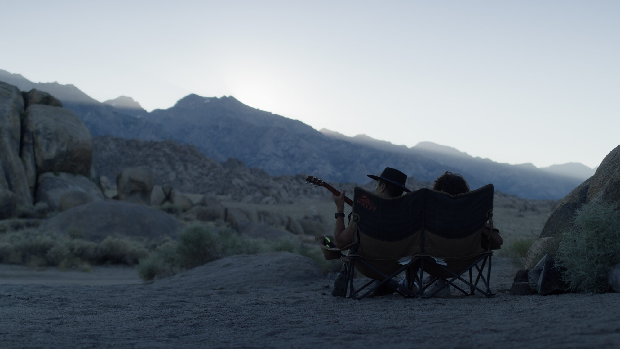 Camp chairs at dusk in the desert below the Sierra