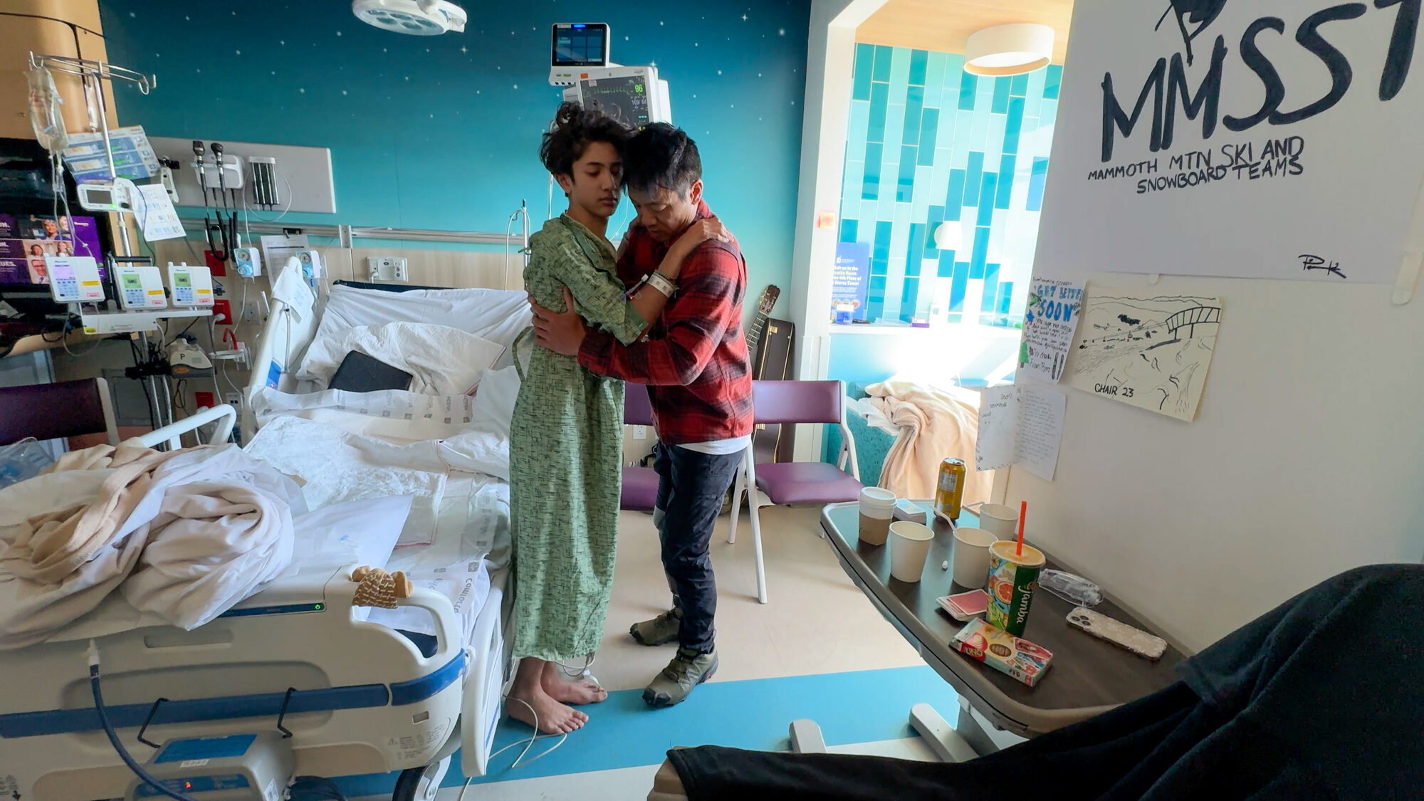 Family holding each other in the ICU room