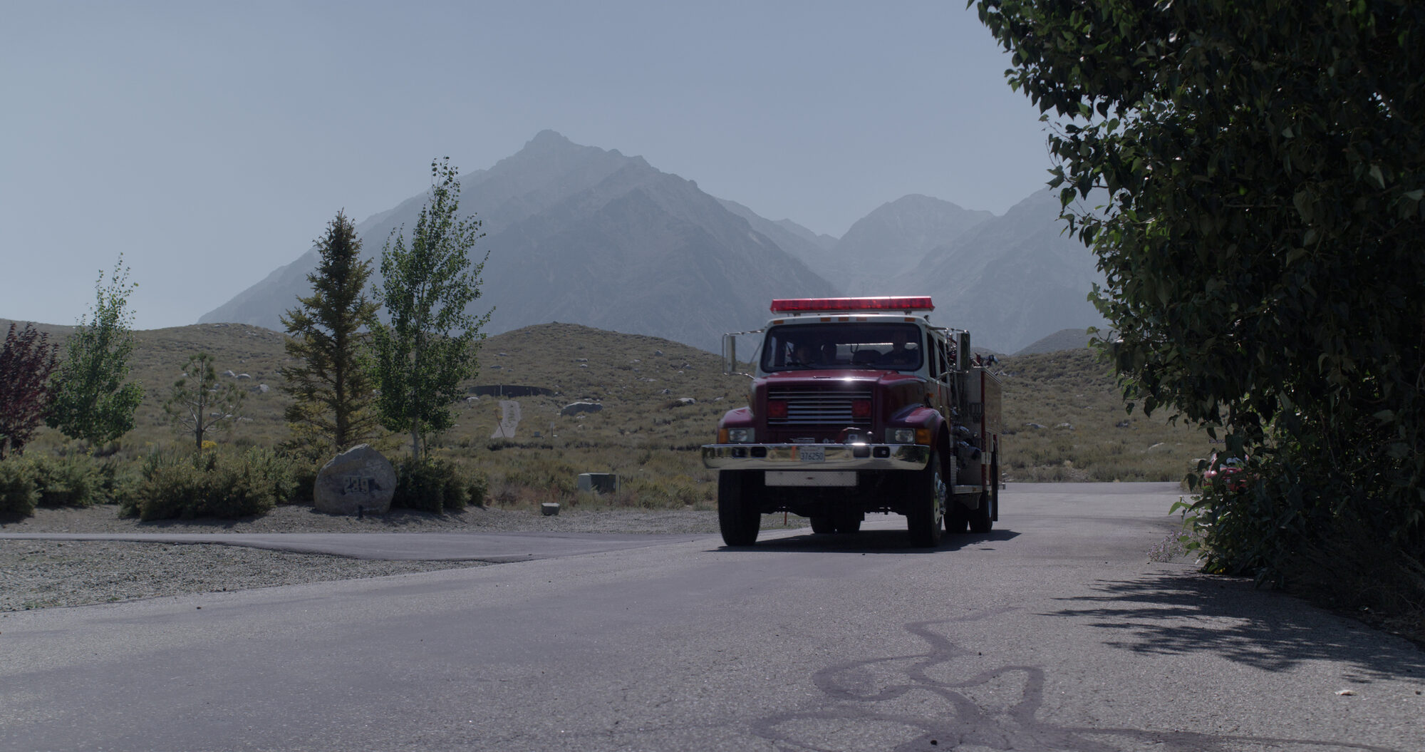 A Mammoth Lakes fire engine on the highway below the Sierra